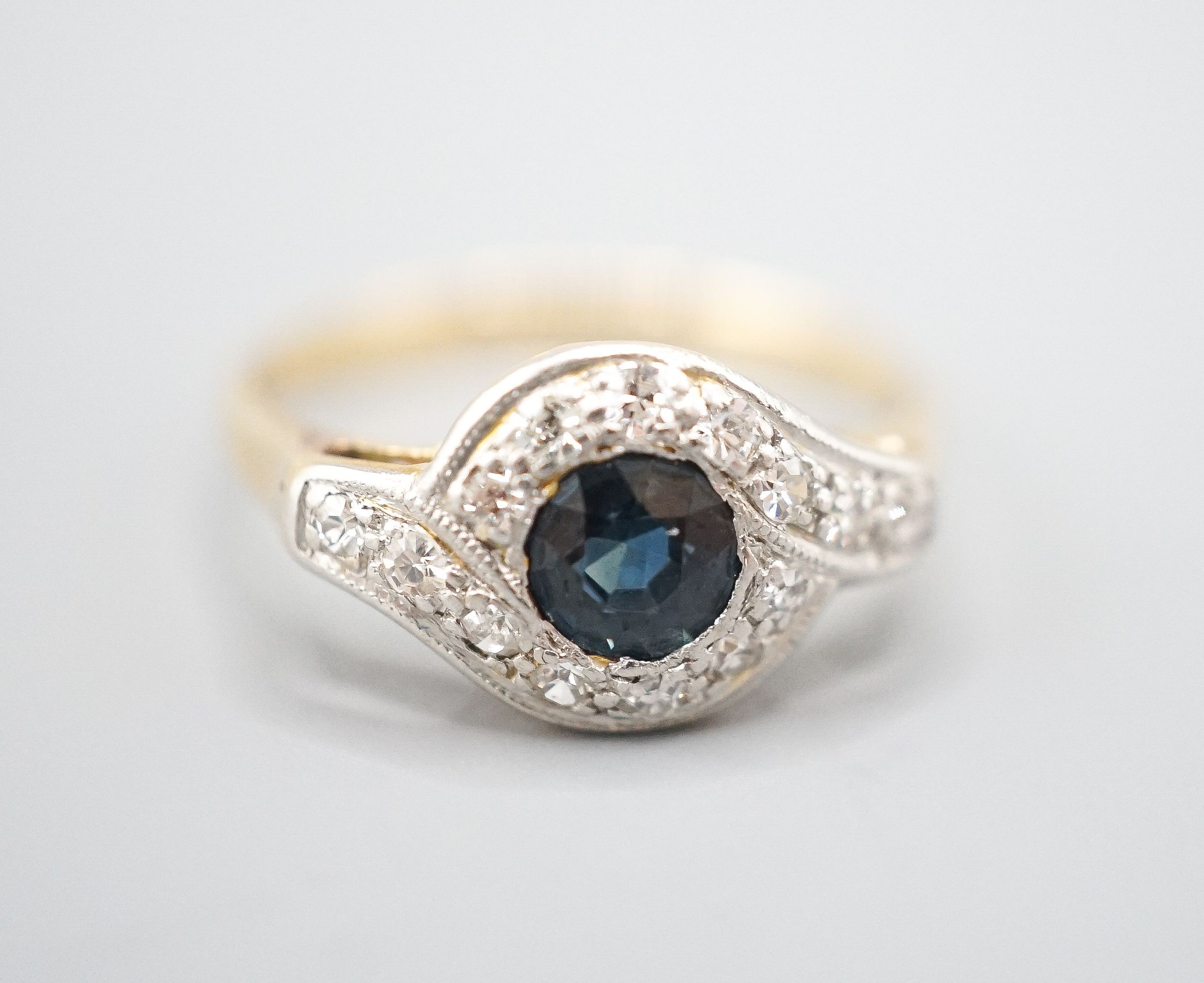 An early to mid 20th century 18ct, sapphire and diamond set cluster ring, size N/O, gross weight 2.6 grams.